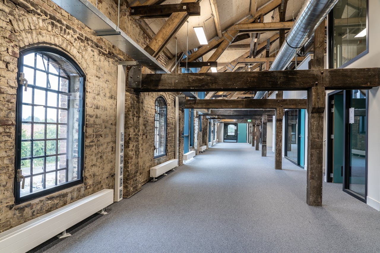 A stylish fusion of modern and rustic in a spacious office hallway interior.